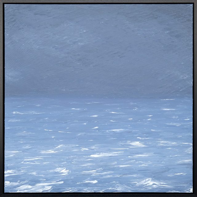 A pale blue sea and textured sky meet at a faint horizon, with bright white wave crests across the foreground in a black frame.