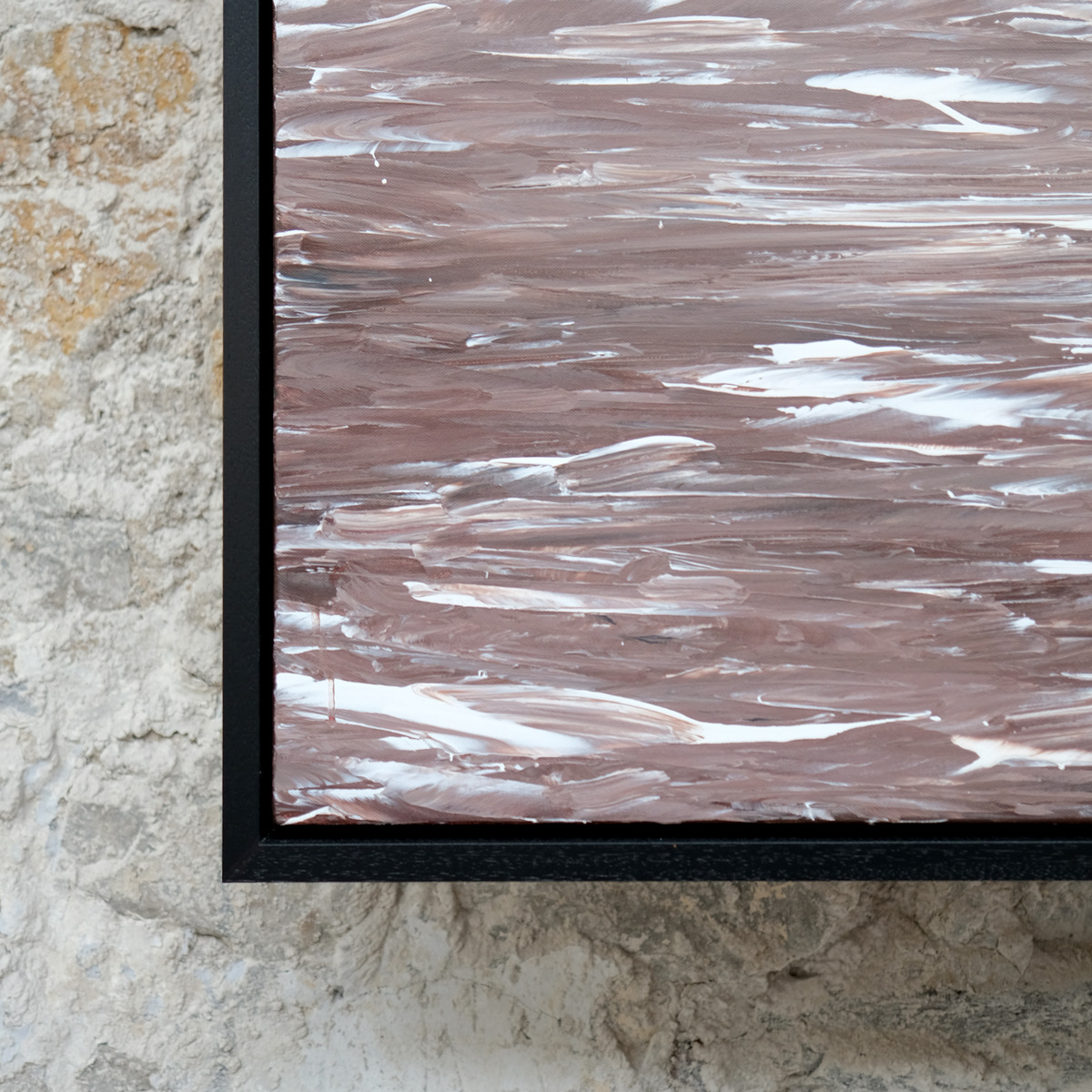 Close-up of the lower-left corner of Rosewake, showing overlapping rose-brown paint and white wave marks beside the black frame.