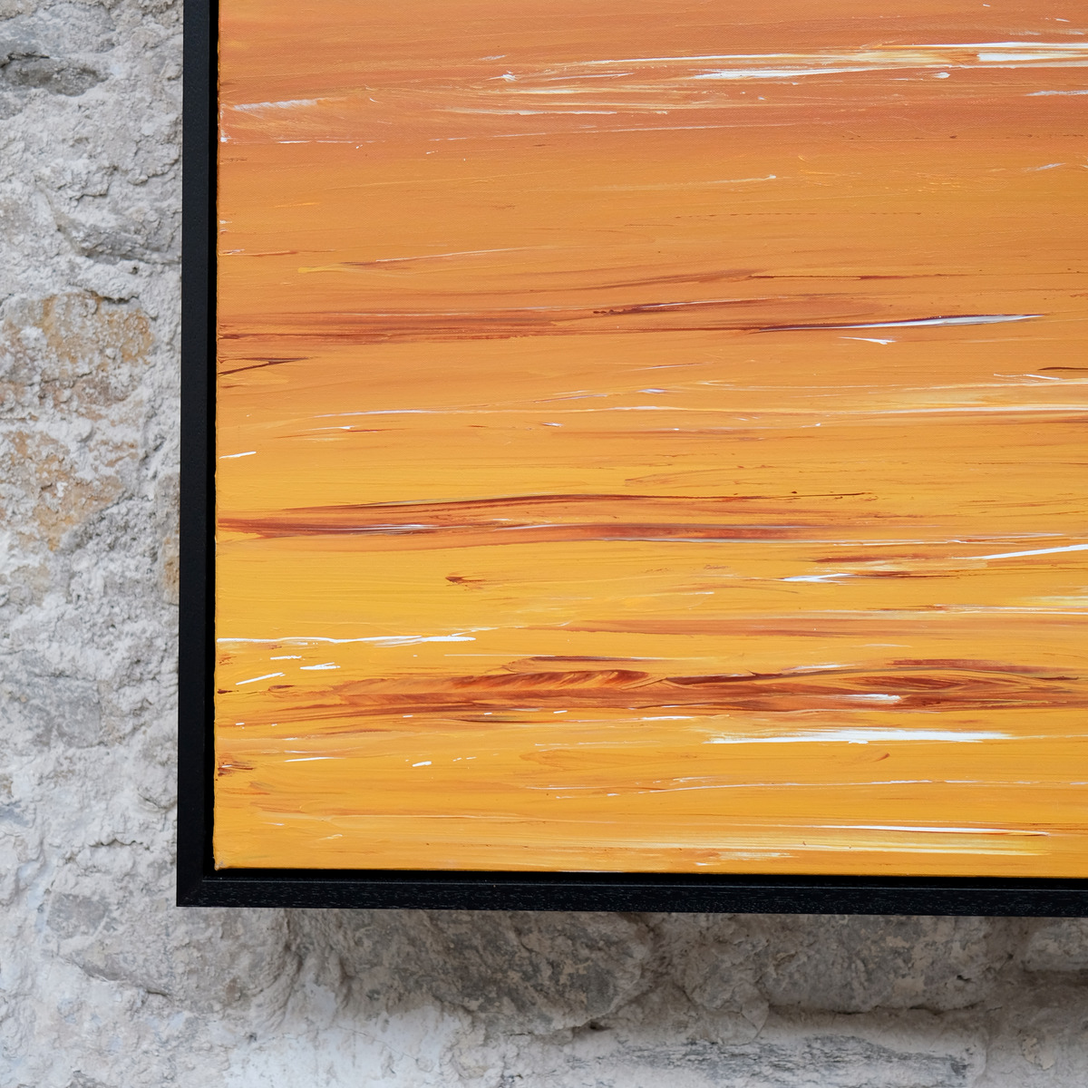 Close-up of the lower-left corner of The Burning Hour, showing golden-yellow and orange painted water with rust-red and white strokes beside the black frame.