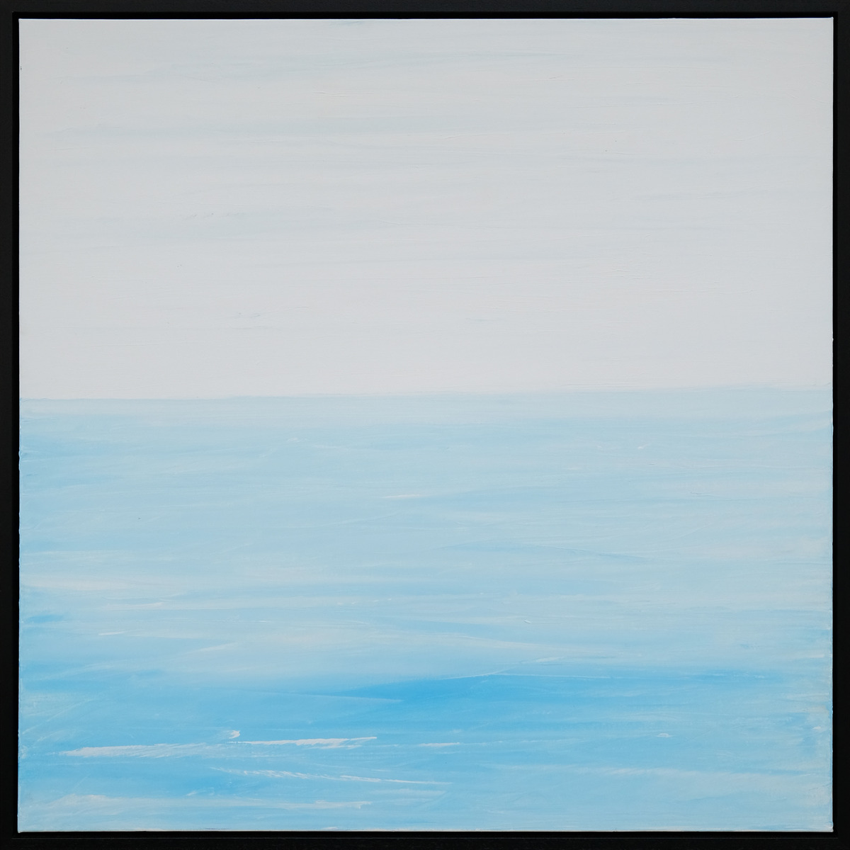 A pale sky meets light blue water with soft white marks and brighter blue passages across the foreground, presented in a black frame.