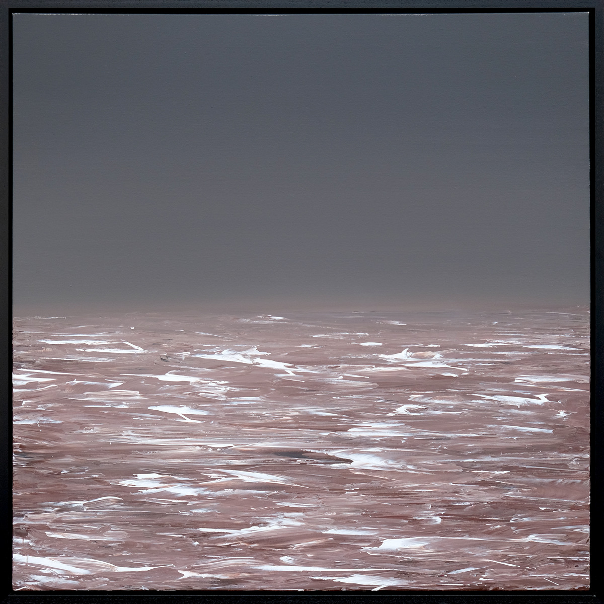 A grey sky meets a muted rose-brown sea, with white wave marks across the water, presented in a black frame.