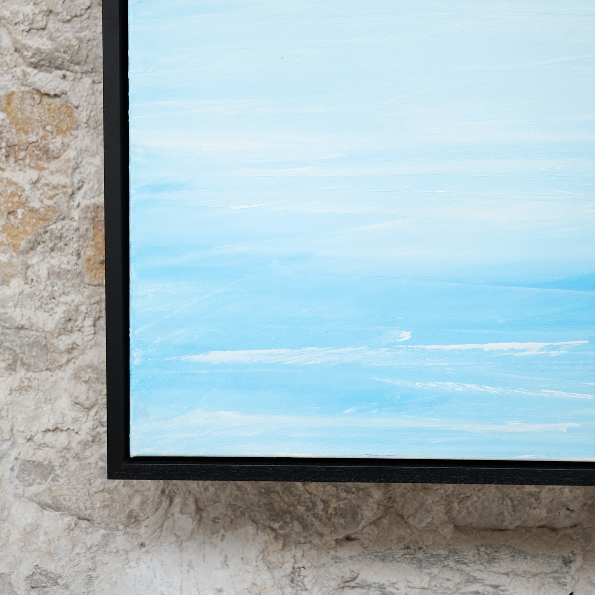 Close-up of the lower-left corner of Pale Distance, showing pale blue and white painted water, canvas texture and the black frame.