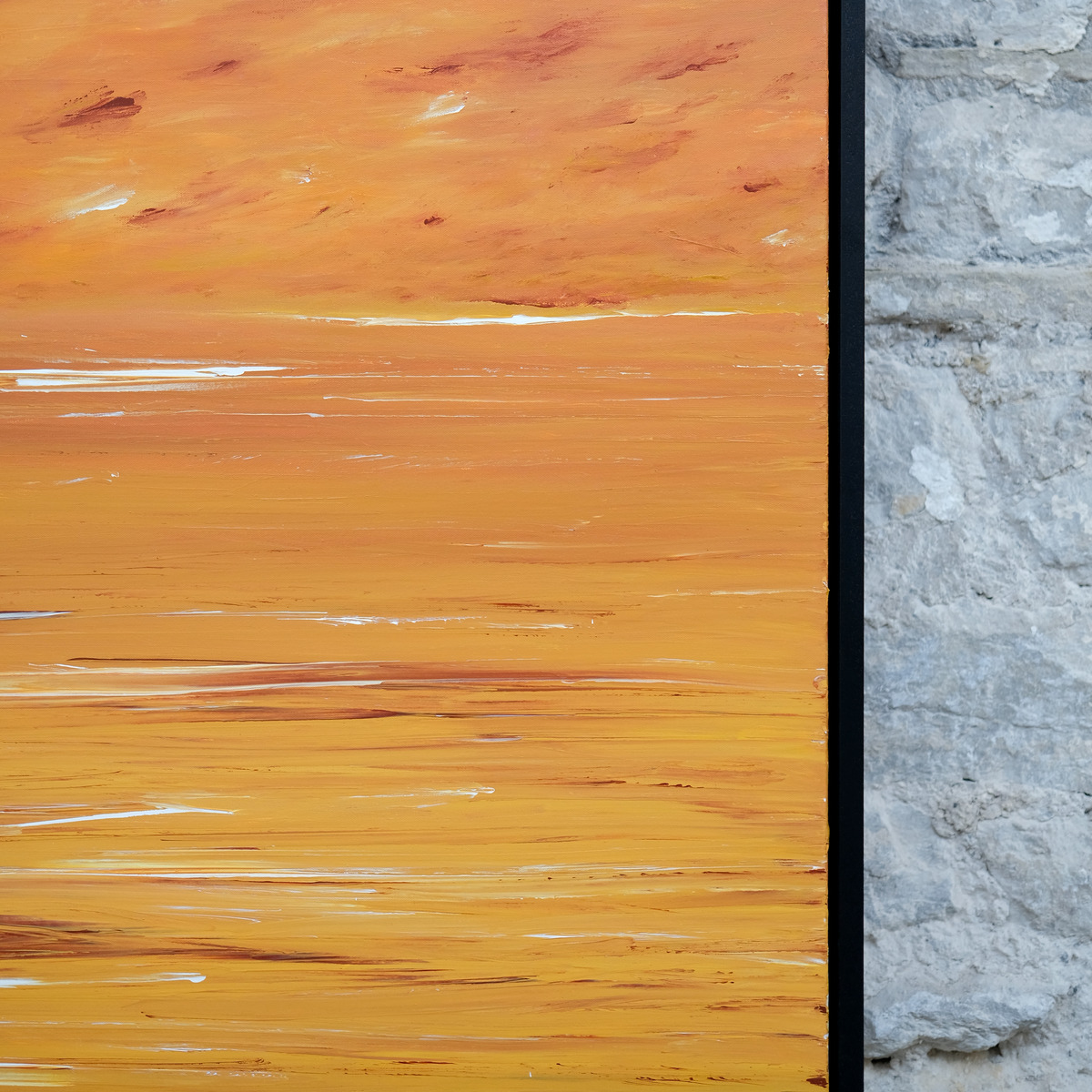 Detail of The Burning Hour showing orange and golden-yellow paint, rust-red marks and fine white horizontal strokes beside the right edge of the black frame.